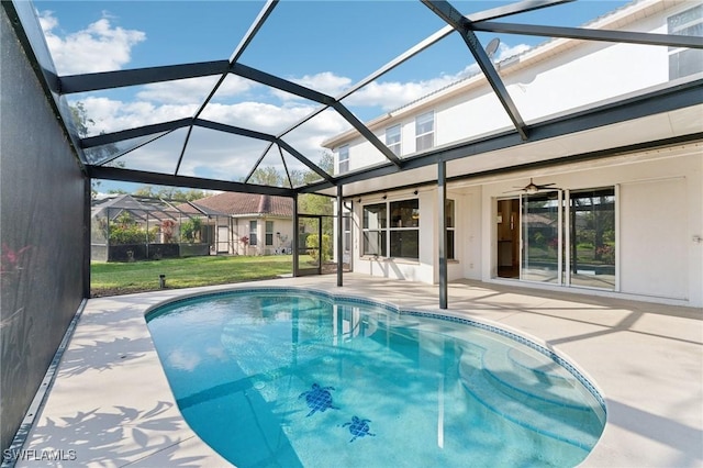 outdoor pool with glass enclosure, ceiling fan, and a patio