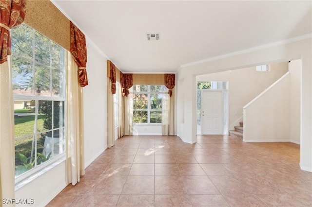 entrance foyer featuring light tile patterned flooring, visible vents, baseboards, ornamental molding, and stairway