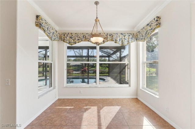 unfurnished dining area with tile patterned flooring, baseboards, and ornamental molding