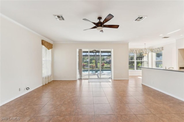 empty room with ceiling fan, visible vents, crown molding, and tile patterned floors