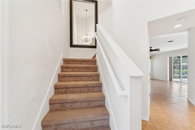 staircase with tile patterned flooring and baseboards