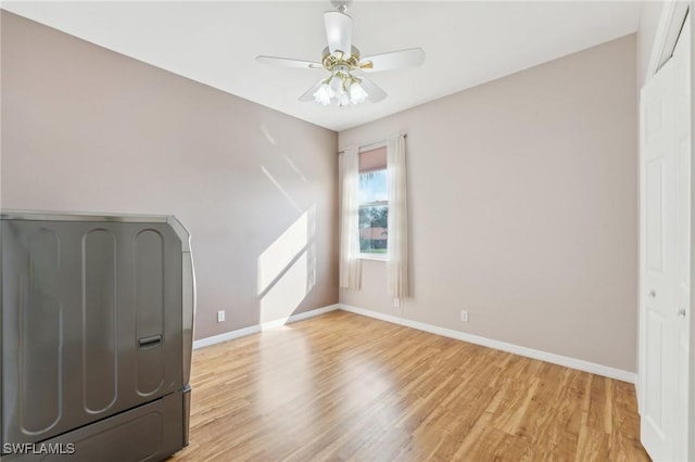 unfurnished bedroom featuring baseboards, a ceiling fan, and light wood-style floors