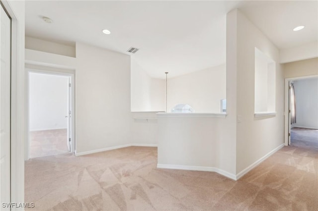 carpeted empty room featuring recessed lighting, visible vents, and baseboards