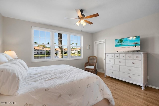 bedroom featuring ceiling fan, wood finished floors, and baseboards