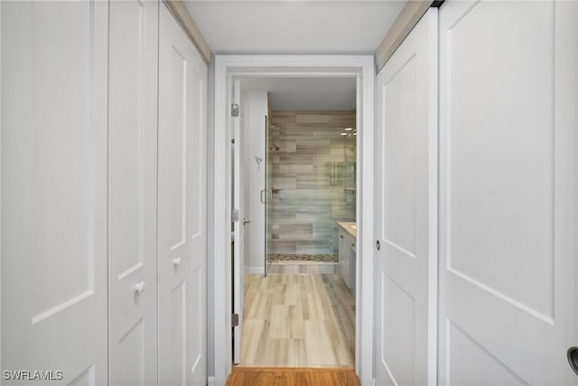 corridor with light wood-type flooring