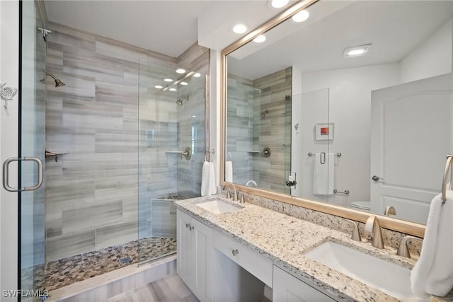 bathroom featuring a sink and a shower stall