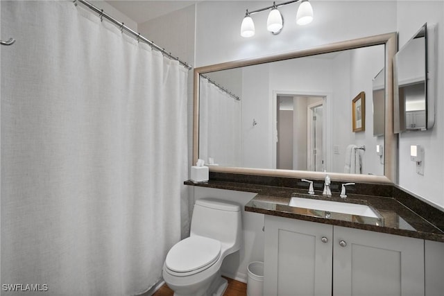 full bathroom featuring vanity and toilet