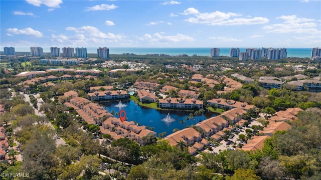 birds eye view of property featuring a view of city and a water view