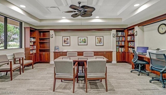 interior space featuring light carpet, ceiling fan, a raised ceiling, and recessed lighting