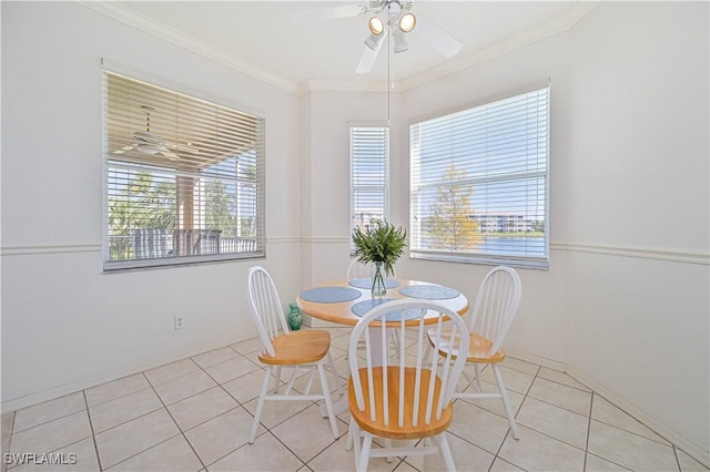 dining area with ornamental molding, light tile patterned flooring, and a ceiling fan