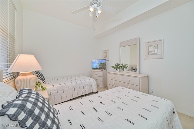 bedroom with light colored carpet, ceiling fan, and baseboards