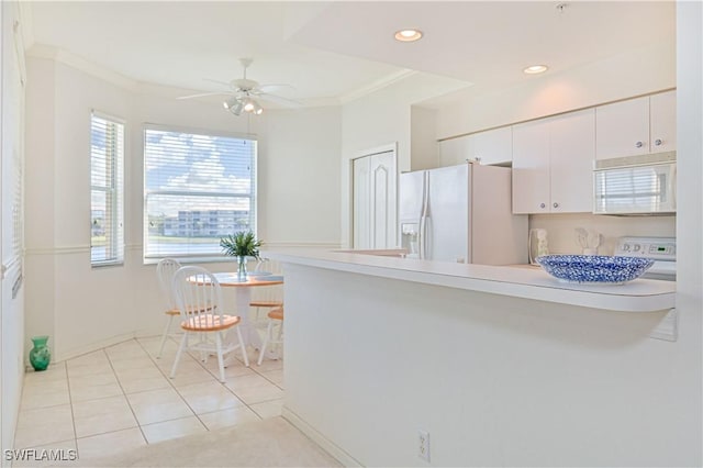 kitchen featuring white appliances, white cabinets, a peninsula, crown molding, and recessed lighting