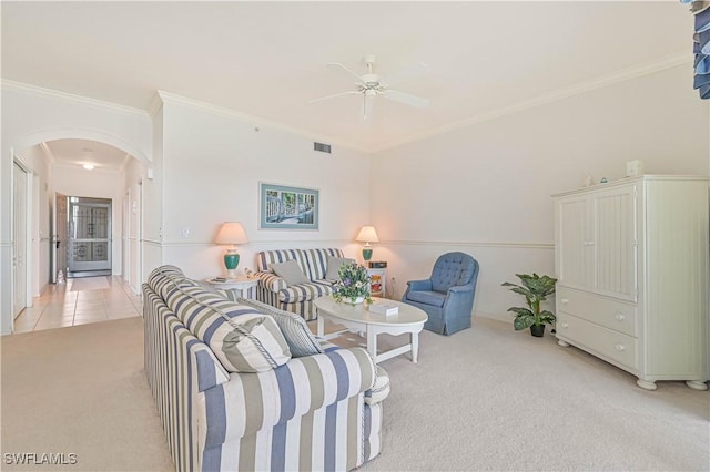 living area with arched walkways, light tile patterned floors, light carpet, visible vents, and crown molding