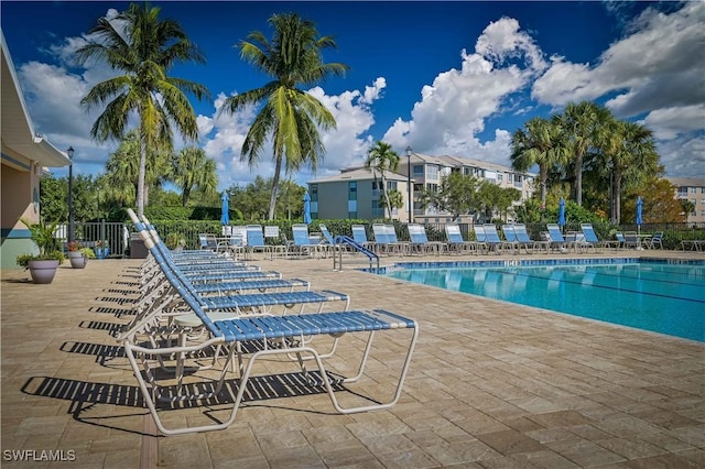 pool featuring a patio and fence