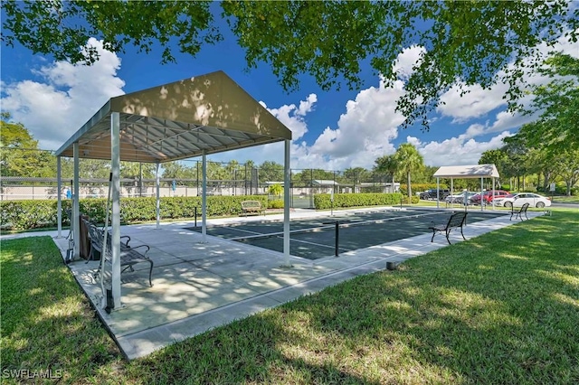 surrounding community featuring fence and a lawn