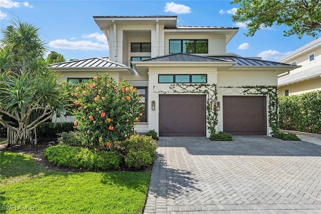 view of front of property with decorative driveway, a standing seam roof, and metal roof