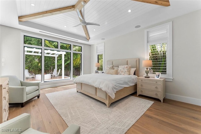 bedroom featuring hardwood / wood-style floors, beamed ceiling, recessed lighting, and baseboards