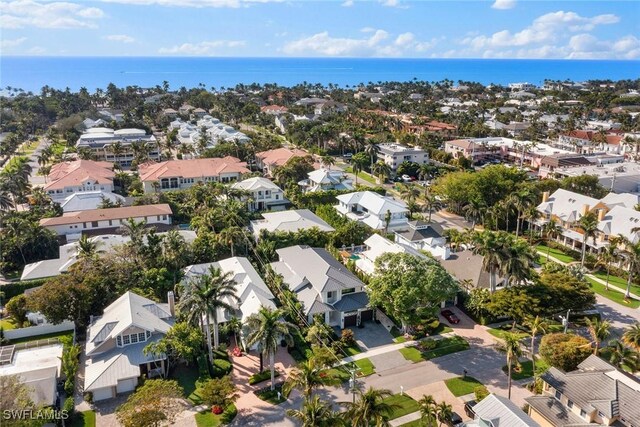 drone / aerial view with a water view and a residential view