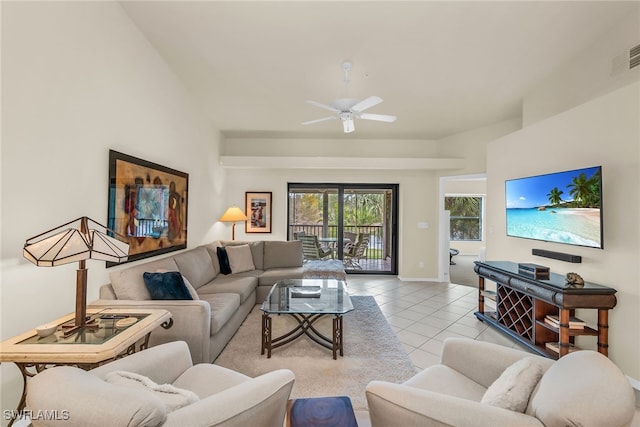 living area with light tile patterned floors, visible vents, baseboards, and a ceiling fan