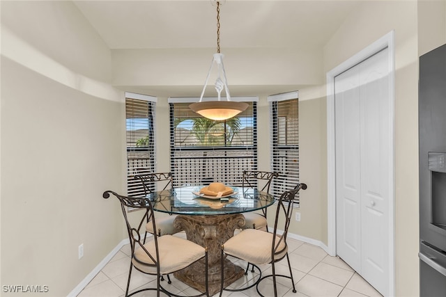 dining area with baseboards and light tile patterned flooring