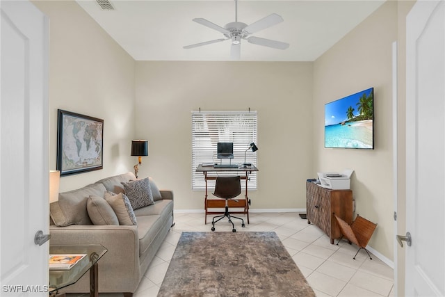 home office with light tile patterned floors, baseboards, and a ceiling fan