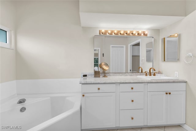 full bath with tile patterned floors, a bath, and vanity