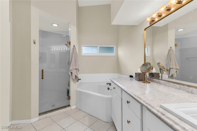 full bath featuring a garden tub, a stall shower, tile patterned flooring, and vanity