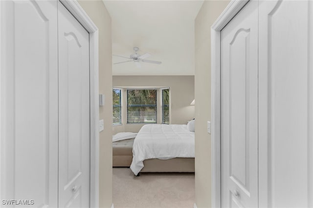 bedroom featuring light colored carpet and ceiling fan