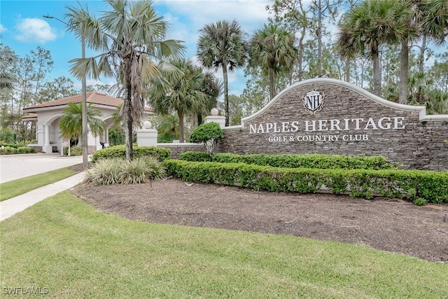 community sign featuring a lawn