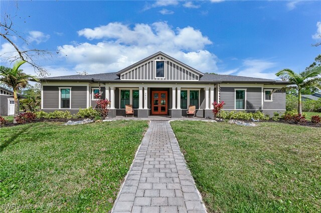 view of front of property with french doors and a front lawn