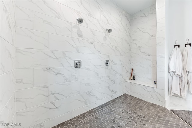 full bath featuring a tile shower