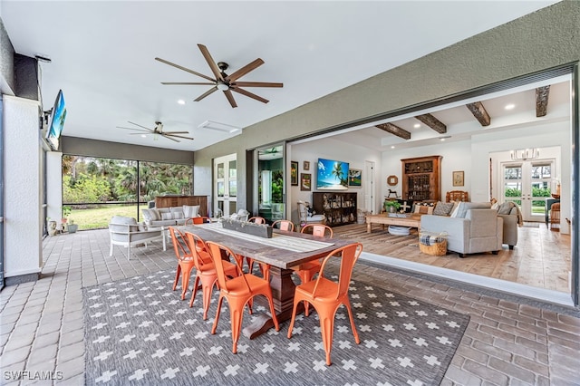 dining room with french doors, beamed ceiling, brick floor, and recessed lighting