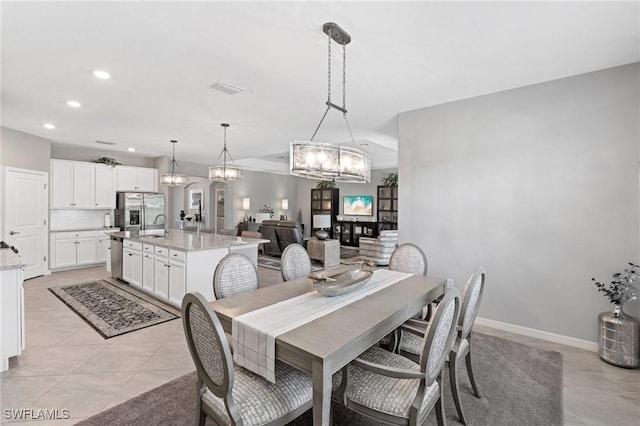 dining room with light tile patterned floors, baseboards, visible vents, a chandelier, and recessed lighting