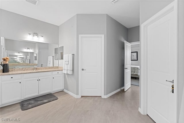 bathroom with tile patterned flooring, visible vents, vanity, and baseboards