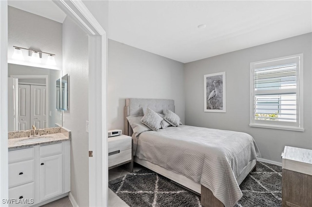 bedroom featuring a sink and baseboards