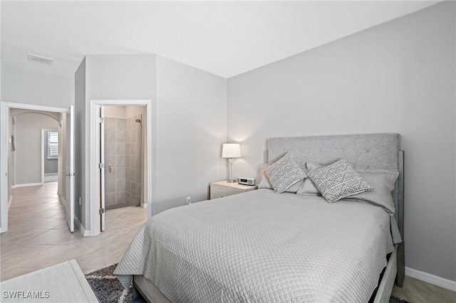 bedroom featuring light tile patterned floors, baseboards, and visible vents