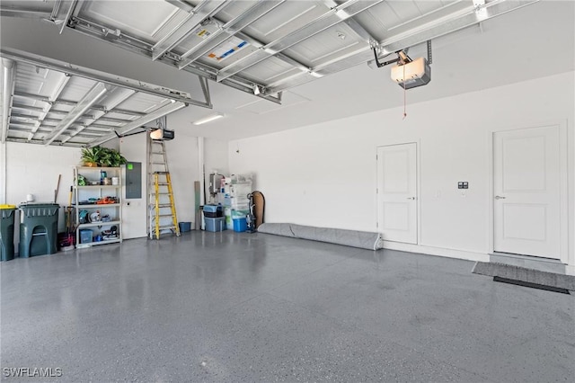 garage with electric panel and a garage door opener