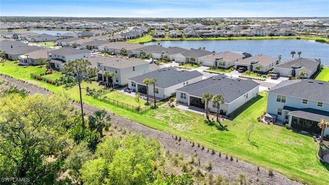 drone / aerial view featuring a residential view and a water view