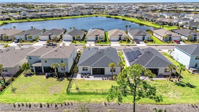 birds eye view of property featuring a residential view and a water view