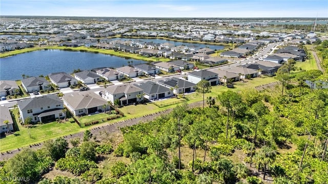 drone / aerial view featuring a water view and a residential view