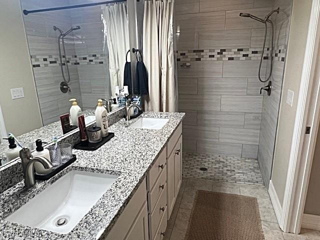 bathroom featuring tiled shower and a sink