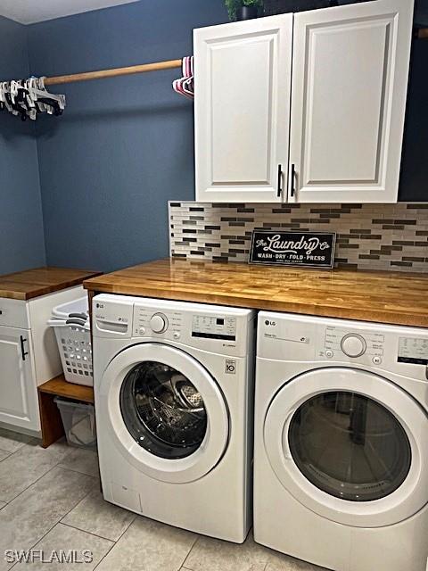 laundry room featuring cabinet space, independent washer and dryer, and light tile patterned floors