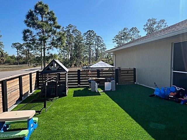 view of yard featuring fence and a gazebo