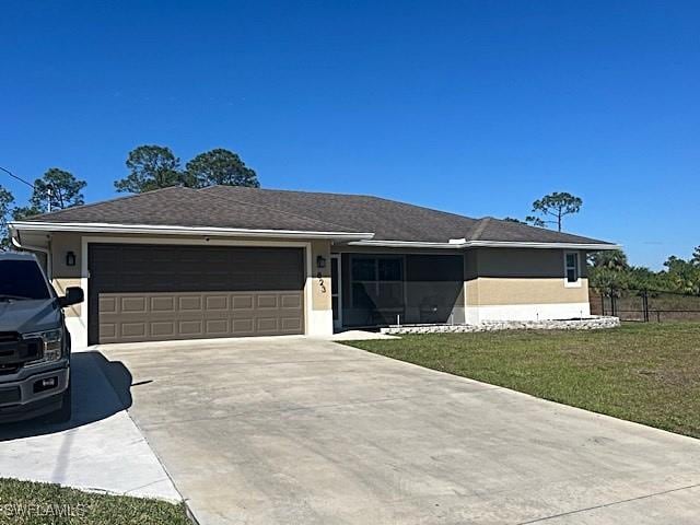 ranch-style house with a garage, fence, concrete driveway, stucco siding, and a front lawn