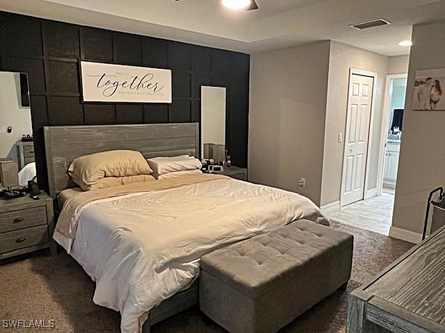 bedroom featuring a ceiling fan, visible vents, and baseboards