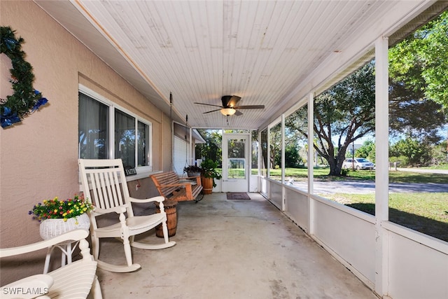 sunroom with wooden ceiling and ceiling fan