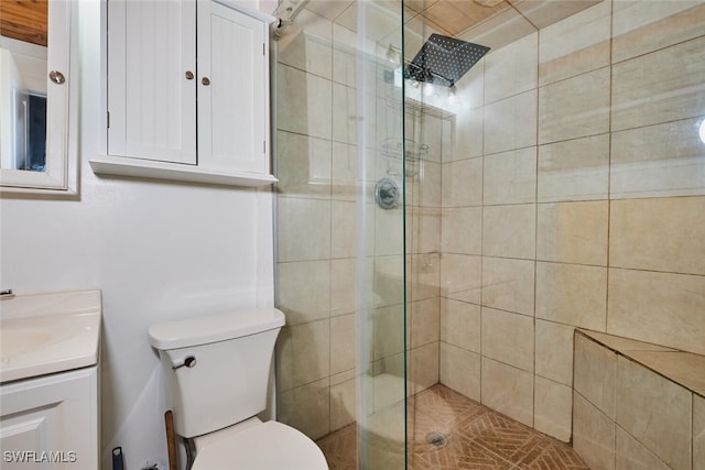 full bath with vanity, a shower stall, and toilet