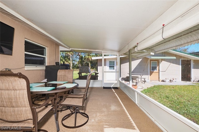 sunroom / solarium featuring lofted ceiling