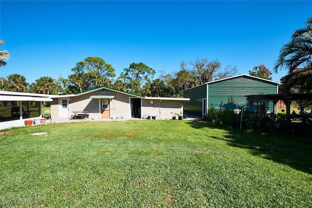 back of house with a yard and a patio area