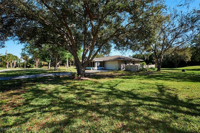 view of yard with a garage and fence